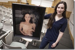 Xania Vlieger poses for a photo with one of her photographs in the room where she will exhibit her work for the Student Showcase in Rasmuson Hall on the campus of the University of Alaska Anchorage in Anchorage, Alaska Friday, April 4, 2014.